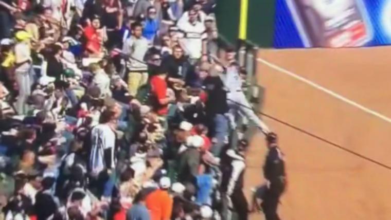 Alex Gordon dives into the stands to make an unbelievable catch image