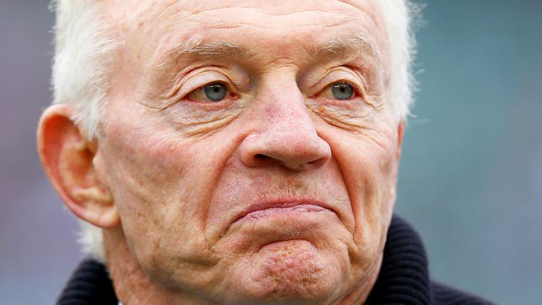 Jerry Jones drops pass, suffers helmet-to-head contact image