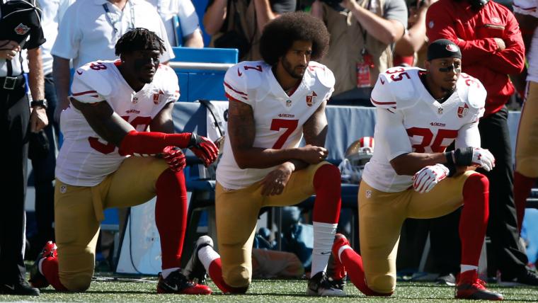 Fan stands on Kaepernick jersey during national anthem image