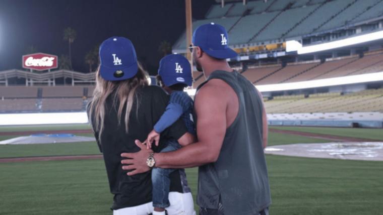 Russell Wilson can't stay away from baseball; visits the Dodgers with Ciara and baby Future image