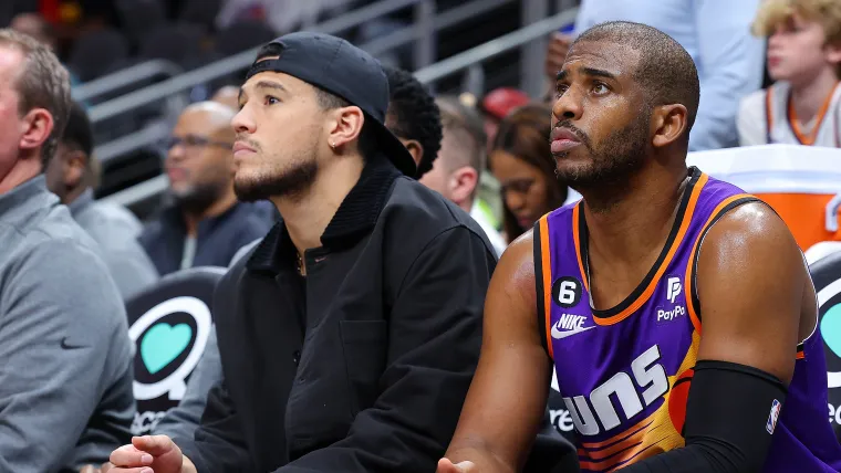 Chris Paul and Devin Booker sitting on the bench