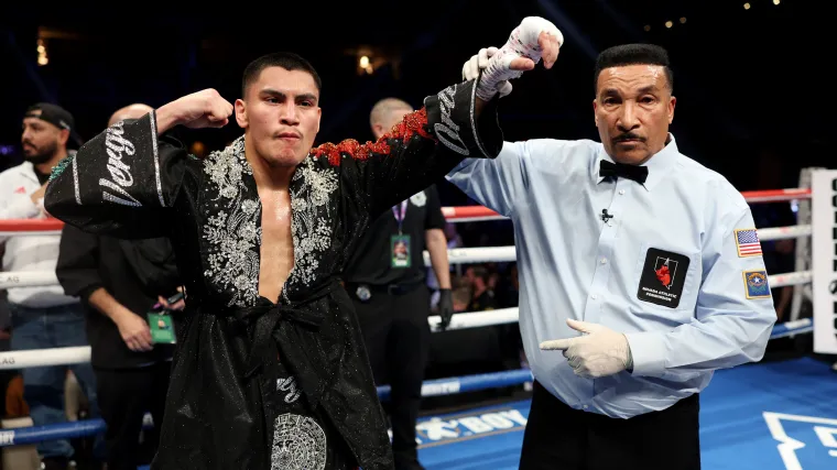 Referee Tony Weeks hold Vergil Ortiz Jr's hand aloft following controversial stoppage