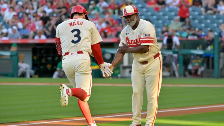 Jun 24, 2024; Anaheim, California, USA; Los Angeles Angels left fielder Taylor Ward (3) is congratulated by third base coach Eric Young Sr. (85) after hitting a two-run home run in the first inning against the Oakland Athletics at Angel Stadium. Mandatory Credit: Jayne Kamin-Oncea-USA TODAY Sports