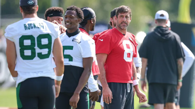 QB Aaron Rodgers (8) wears red practice jersey