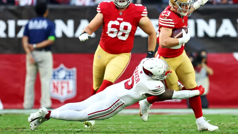 Dec 17, 2023; Glendale, Arizona, USA; San Francisco 49ers running back Christian McCaffrey (23) runs the ball against Arizona Cardinals safety Budda Baker (3) during the first half at State Farm Stadium. Mandatory Credit: Mark J. Rebilas-USA TODAY Sports