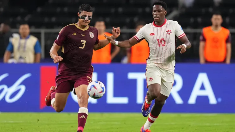 Canada's Jonathan David battles with Venezuela's Yordan Osorio for the ball