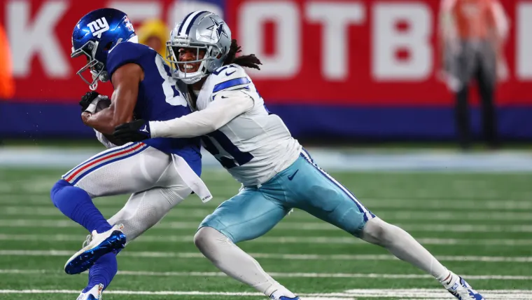 Sep 10, 2023; East Rutherford, New Jersey, USA; Dallas Cowboys cornerback Stephon Gilmore (21) tackles New York Giants wide receiver Darius Slayton (86) during the second half at MetLife Stadium. Mandatory Credit: Ed Mulholland-USA TODAY Sports