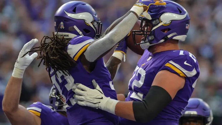 Minnesota Vikings offensive lineman Ezra Cleveland (72) celebrates with Dalvin Cook (33)