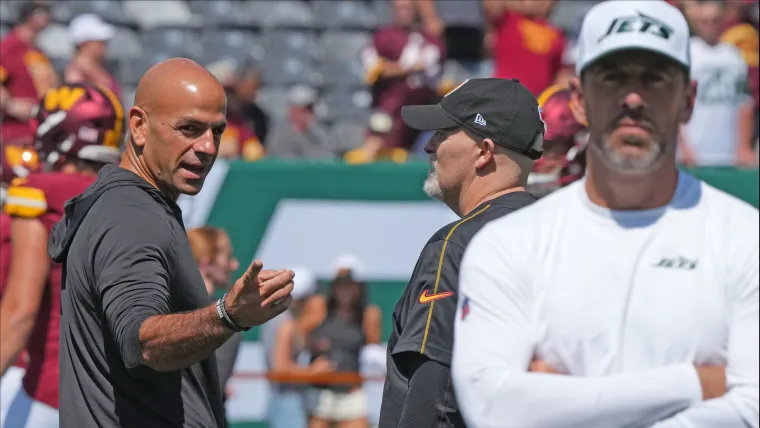 Robert Saleh gestures toward Aaron Rodgers