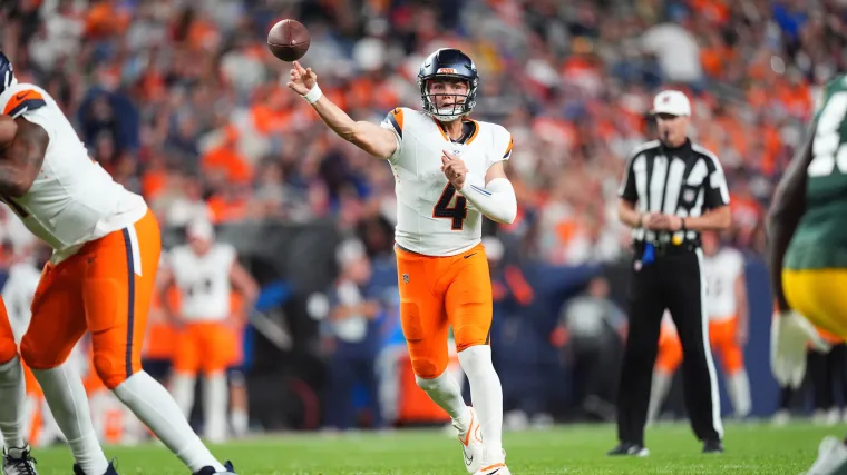 Zach Wilson throws a pass for Denver