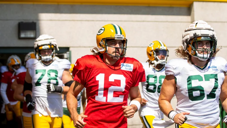 Aaron Rodgers (12) and Jake Hanson (67)