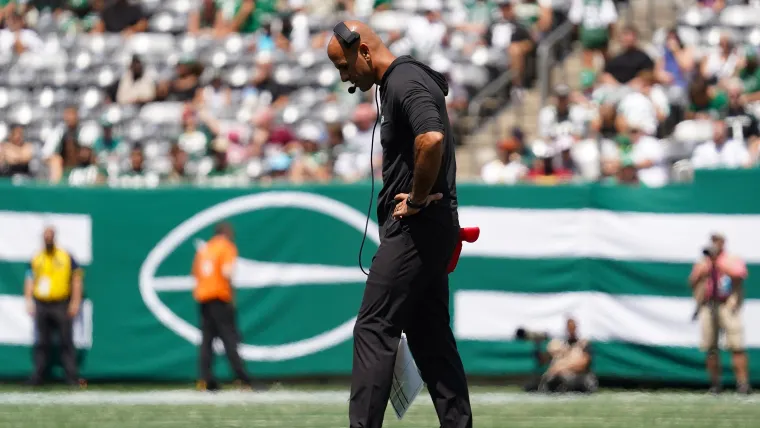 Robert Saleh looks down at field