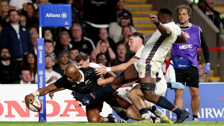 Mark Tele'a of New Zealand scores a try against England