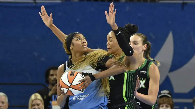 Chicago Sky forward Angel Reese (5) drives to the basket against Minnesota Lynx forward Alanna Smith (8) and forward Napheesa Collier (24)